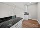 Functional laundry room with overhead shelving, black countertop, and convenient sink at 297 Barr Link Rd, Mount Pleasant, NC 28124