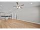 Bright living room with vaulted ceilings, modern fan, and hardwood floors leading to kitchen at 297 Barr Link Rd, Mount Pleasant, NC 28124