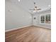 Bright living room with vaulted ceilings, recessed lighting and hardwood floors. Door to exterior at 297 Barr Link Rd, Mount Pleasant, NC 28124