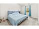 Cozy bedroom with a comfortable bed, soft carpet, and a large window at 3118 Maple Ridge Dr # 11, Gastonia, NC 28052