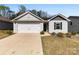 Charming single-story home with a well-maintained lawn, a two-car garage and welcoming curb appeal at 3118 Maple Ridge Dr # 11, Gastonia, NC 28052