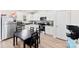 Modern kitchen with white cabinetry, stainless steel appliances, and adjacent dining area at 3118 Maple Ridge Dr # 11, Gastonia, NC 28052