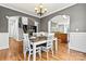 Open-concept dining room with modern light fixture, view of staircase, fireplace and kitchen at 3207 Oak Ridge Cir, Lincolnton, NC 28092