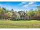 Charming home with stone accents, a covered porch, and a lush front yard at 3207 Oak Ridge Cir, Lincolnton, NC 28092