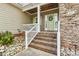Inviting front porch with brick steps, stone accents, and charming details at 3207 Oak Ridge Cir, Lincolnton, NC 28092