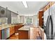 Bright kitchen with stainless steel appliances, granite countertops, wood cabinets, and a cozy breakfast nook at 3207 Oak Ridge Cir, Lincolnton, NC 28092