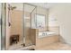 Bathroom boasts a glass-enclosed shower and a separate soaking tub with tile surround at 3207 Oak Ridge Cir, Lincolnton, NC 28092