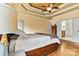 Sunny main bedroom featuring a trey ceiling, hardwood floors, and ensuite bathroom at 3207 Oak Ridge Cir, Lincolnton, NC 28092