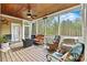 Relaxing screened-in porch with wood ceiling, ceiling fan, and comfortable seating, perfect for enjoying the outdoors at 3207 Oak Ridge Cir, Lincolnton, NC 28092