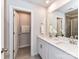 Bathroom featuring double sinks, quartz countertop and a doorway to the toilet and shower at 3524 Auburn Curb Rd, Charlotte, NC 28217