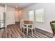 Cozy dining area with wood-look floors, natural light, and an adjacent stainless steel refrigerator at 3524 Auburn Curb Rd, Charlotte, NC 28217