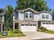 Charming townhouse with a two-car garage, stone accents, and manicured landscaping at 3524 Auburn Curb Rd, Charlotte, NC 28217