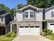 Charming townhouse with a two-car garage, stone accents, and manicured landscaping at 3524 Auburn Curb Rd, Charlotte, NC 28217