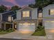 Charming two-story townhome with stone accents, a double garage, and well-manicured landscaping at 3524 Auburn Curb Rd, Charlotte, NC 28217