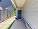 Inviting front entrance with a wreath, flowers, and stone accents for added curb appeal at 3524 Auburn Curb Rd, Charlotte, NC 28217