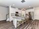 Modern kitchen features stainless steel appliances, white cabinetry, and a granite island with seating at 3524 Auburn Curb Rd, Charlotte, NC 28217