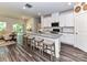 Bright kitchen with island, seating, and an adjacent living area with sliding glass door and natural light at 3524 Auburn Curb Rd, Charlotte, NC 28217