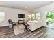 Cozy living room featuring hardwood floors, neutral tones, and a sliding glass door at 3524 Auburn Curb Rd, Charlotte, NC 28217