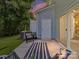 Enjoy outdoor living with a cozy patio featuring a wicker chair, striped rug, and sliding glass doors at 3524 Auburn Curb Rd, Charlotte, NC 28217