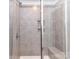 Modern tiled shower with built-in shelving and a glass door at 3524 Auburn Curb Rd, Charlotte, NC 28217