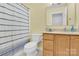 Well-lit bathroom with tiled shower, vanity and sink with wooden cabinets at 365 Kinder Rd, Harmony, NC 28634