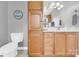 Charming bathroom featuring wood cabinetry, a vanity with ample storage, and a well-lit mirror at 365 Kinder Rd, Harmony, NC 28634
