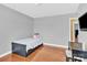 Bedroom with hardwood floors and a mounted flat screen tv near the corner entrance at 365 Kinder Rd, Harmony, NC 28634