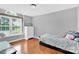 Bright bedroom featuring hardwood floors, a large window and a white chest of drawers at 365 Kinder Rd, Harmony, NC 28634