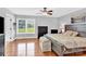 Sun-drenched bedroom features hardwood floors, a rustic wood bed frame, and ample natural light at 365 Kinder Rd, Harmony, NC 28634