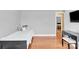 A bedroom with hardwood floors, a bed and a desk near the wall with open door at 365 Kinder Rd, Harmony, NC 28634