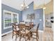 Bright dining room with a large window, stylish table set, a view of the kitchen and modern flooring at 365 Kinder Rd, Harmony, NC 28634