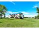 View of a two-story home featuring a garage, covered porch, and large landscaped yard at 365 Kinder Rd, Harmony, NC 28634