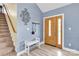 Inviting foyer with a staircase, a wooden-doored entryway, light blue walls, and a decorative wall piece at 365 Kinder Rd, Harmony, NC 28634