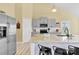 Bright kitchen with an island, stainless steel appliances, gray cabinets, and barstool seating at 365 Kinder Rd, Harmony, NC 28634