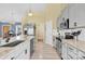 Open kitchen with island, stainless steel appliances, and seamless flow to the breakfast nook and living area at 365 Kinder Rd, Harmony, NC 28634