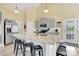 Spacious kitchen with a granite island, stainless steel appliances, gray cabinets, and modern lighting at 365 Kinder Rd, Harmony, NC 28634