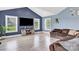 Inviting living room with vaulted ceilings, large windows and stylish gray laminate flooring at 365 Kinder Rd, Harmony, NC 28634