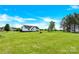 Large property with manicured lawn featuring rear view of the house and a charming treehouse at 365 Kinder Rd, Harmony, NC 28634