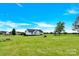 Rear exterior of house has large lot with manicured lawn and a charming, elevated treehouse at 365 Kinder Rd, Harmony, NC 28634
