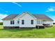 The back exterior shows a lovely yard, deck, hot tub, and treehouse on a sunny day at 365 Kinder Rd, Harmony, NC 28634