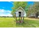 Elevated treehouse with a charming design nestled amongst mature trees on a large lawn at 365 Kinder Rd, Harmony, NC 28634