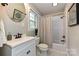 Clean, updated bathroom with a shower-tub combo, modern vanity, and good natural light at 3701 Slagle Dr, Charlotte, NC 28215