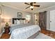 Charming bedroom with hardwood floors, ceiling fan, and bathroom access via sliding door at 3701 Slagle Dr, Charlotte, NC 28215