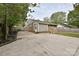 Home featuring a large concrete driveway, partial fencing, and a mixture of vinyl and brick siding at 3701 Slagle Dr, Charlotte, NC 28215