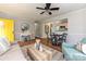 Bright living room boasts a yellow door, hardwood floors, dining table, and an open view into the kitchen at 3701 Slagle Dr, Charlotte, NC 28215