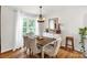 Bright dining room features a wooden table with cushioned chairs and a lovely chandelier at 3790 Lynnview Ct, Maiden, NC 28650