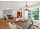 Open-concept dining area with a view into the living room with natural light at 3790 Lynnview Ct, Maiden, NC 28650