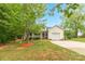 Traditional home with a cozy front porch, attached garage, driveway and a mature trees on a lush green lawn at 3790 Lynnview Ct, Maiden, NC 28650