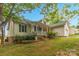 Traditional home with a cozy front porch, attached garage, beautifully landscaped yard with mature trees at 3790 Lynnview Ct, Maiden, NC 28650