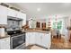 Kitchen with stainless steel appliances, white cabinets, and view to the dining room at 3790 Lynnview Ct, Maiden, NC 28650